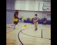 Man dressed as wolf in yellow outfit basketball