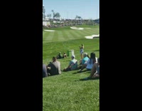 Woman sits on boyfriends shoulders at baseball game