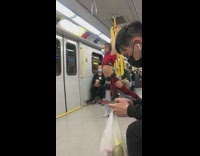 Man in ripped up red outfit hanging off rails
