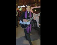 Christmas carolers sing Feliz Navidad with live band on the street