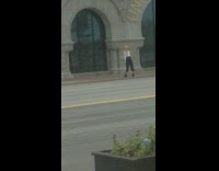 Blonde Lady Films Dance Video on Sidewalk with Phone Attached to Window 