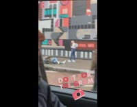 Photographer on floor girl takes picture in front of mural