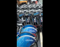 Man shows multiple citibikes parked on street