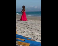 Woman red dress hold guitar beach chair