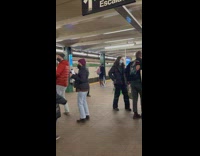 People dancing to subway performer playing guitar