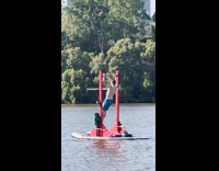 Man do pull ups on boat river