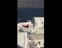 Red dress girl poses white dome rooftop 
