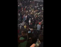Guy jumps fence and gets tackled by security at concert 