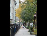 Man on sidewalk walking on stilts 