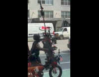 Collab WINY - Man push bike filled with random accessories