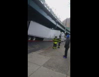 Semi truck gets stuck under green freeway bridge and breaks in half