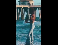 Woman hold pineapple raise leg beach bridge