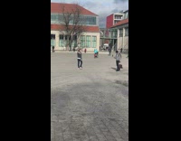 Guy takes video of friend fixing hair in town square