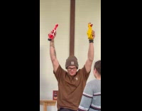 Guy brown shirt raise squeeze rubber chicken