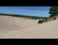 Guy on motorbike goes airborne off sand hill and falls off at landing