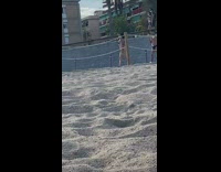 Black bikini girl walks puts sunglasses on 