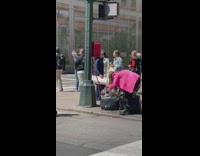 Woman orange cap pedestrian street trash bags