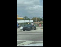 Woman twerk over convertible car during stoplight