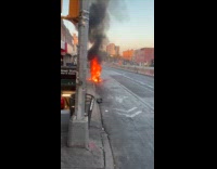 Motorcycle parked on street on fire