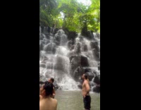 Tourists in different photoshoot by the waterfalls