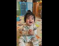 Toddler laughing so hard they fall backwards