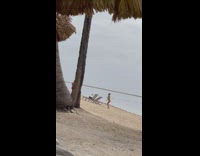 Woman yellow bikini dance on beach overcast