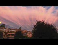 Thick beautiful sunset clouds over neighborhood apartments