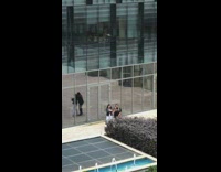 Two women tiktok dance near the water fountain
