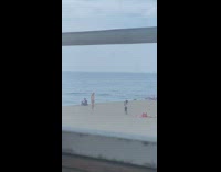 Little girl take picture of woman bikini beach