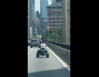 Guy white shirt rides ATV at bridge