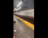 Guy blows bubbles on the train platform