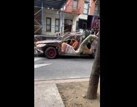 Man drives junk car with music videos playing 