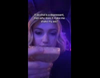 Woman stares and drinks at the bar