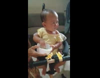 Baby yellow shirt use hand to eat