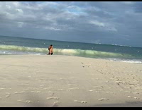 Man shirtless circles from the woman at the beach