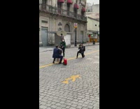 Guy suit sits backwards chair street photoshoot