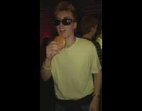 Guy wearing dad outfit at club pulls burger out of pocket and eats