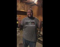 Guy lifts weights garage red hat spotter 