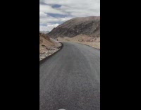 Man Travels on Motorbike Attentively Through Badlands