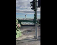 Woman white pants stand over bridge metal