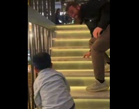 Boy laughs when man trips and falls 