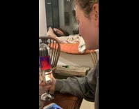 Girl at table looking at lava lamp candle