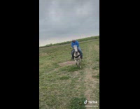 Guy rides by on horse making weird sound