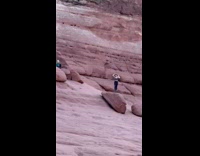 Collab IITW - Woman tank top black pants poses on the canyon at sunset