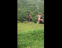 couple kissing in park while being held