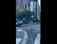 Man juggling pins in middle of crosswalk