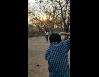 Girl white blouse walk towards photographer trees