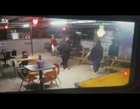 Drunk guy swings on stripper pole and falls down at bar