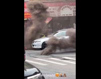 Thick black smoke comes out of manhole 
