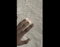 Person tap on wall makes fingers glow